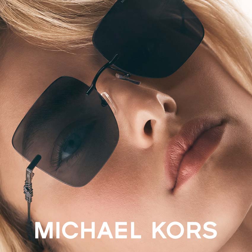 Woman modeling Michael Kors sunglasses